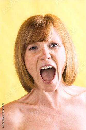unhappy woman is looking angrily and is screaming photo