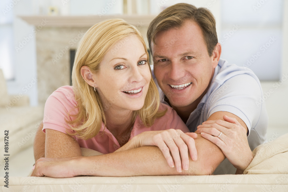 Couple relaxing in living room and smiling Couple relaxing in living room and smiling