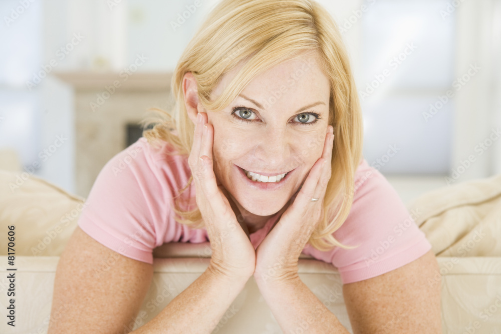 Woman sitting in living room smiling Woman sitting in living room smiling