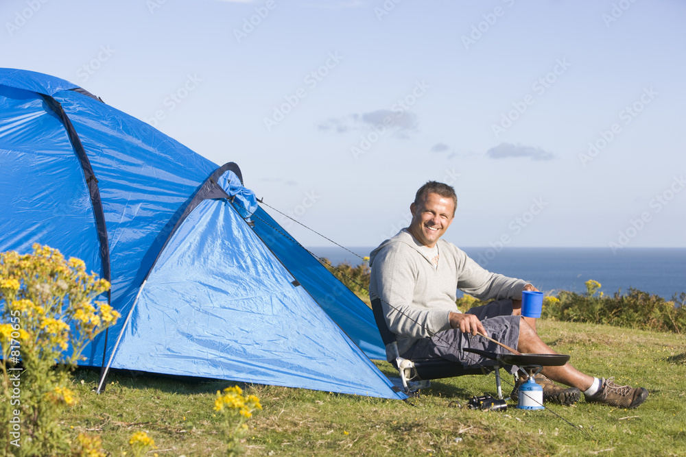 Man camping and cooking