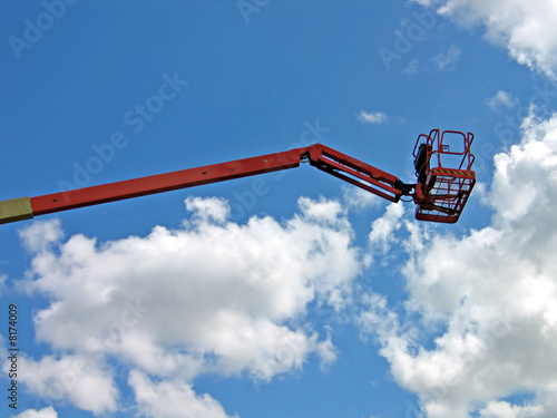 Tall mobile crane with sky background