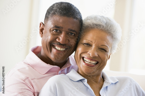 Couple relaxing in living room and smiling © Monkey Business