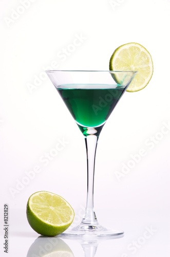 Green cocktail with green lemon on white background