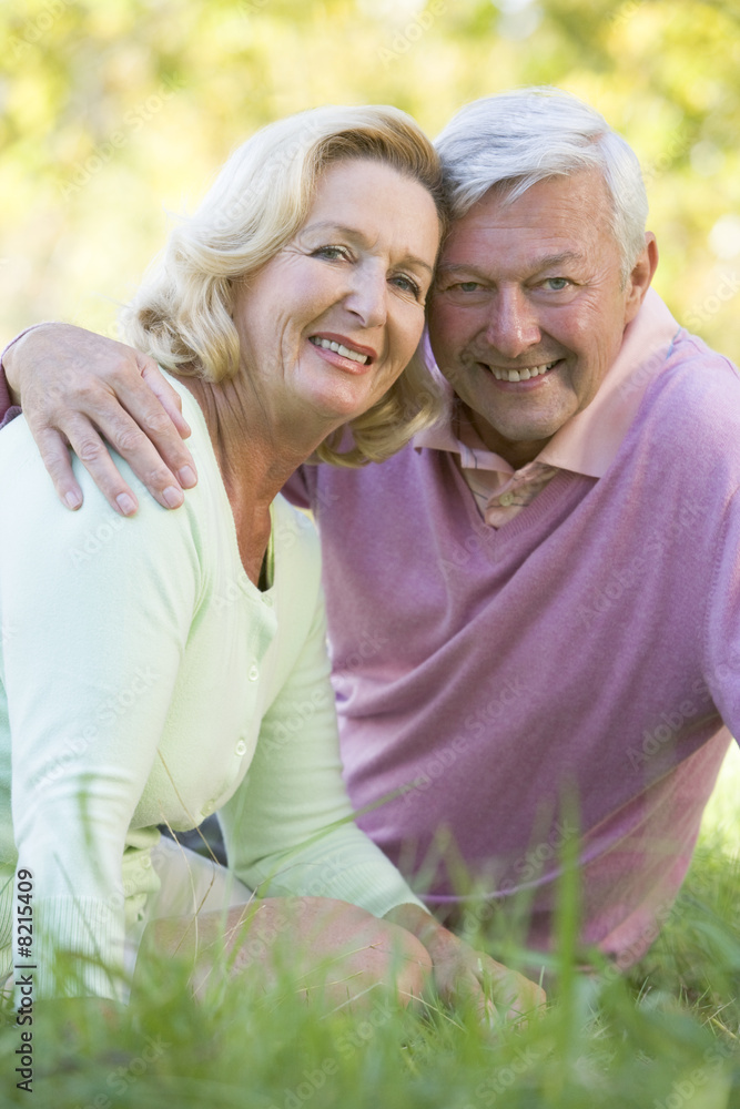 Couple relaxing in park smiling