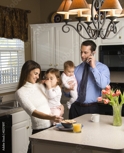 Family in kitchen.