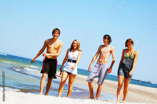 Young friends on the summer beach