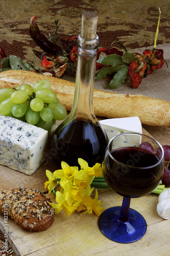 Wine, cheese, grapes and herbs