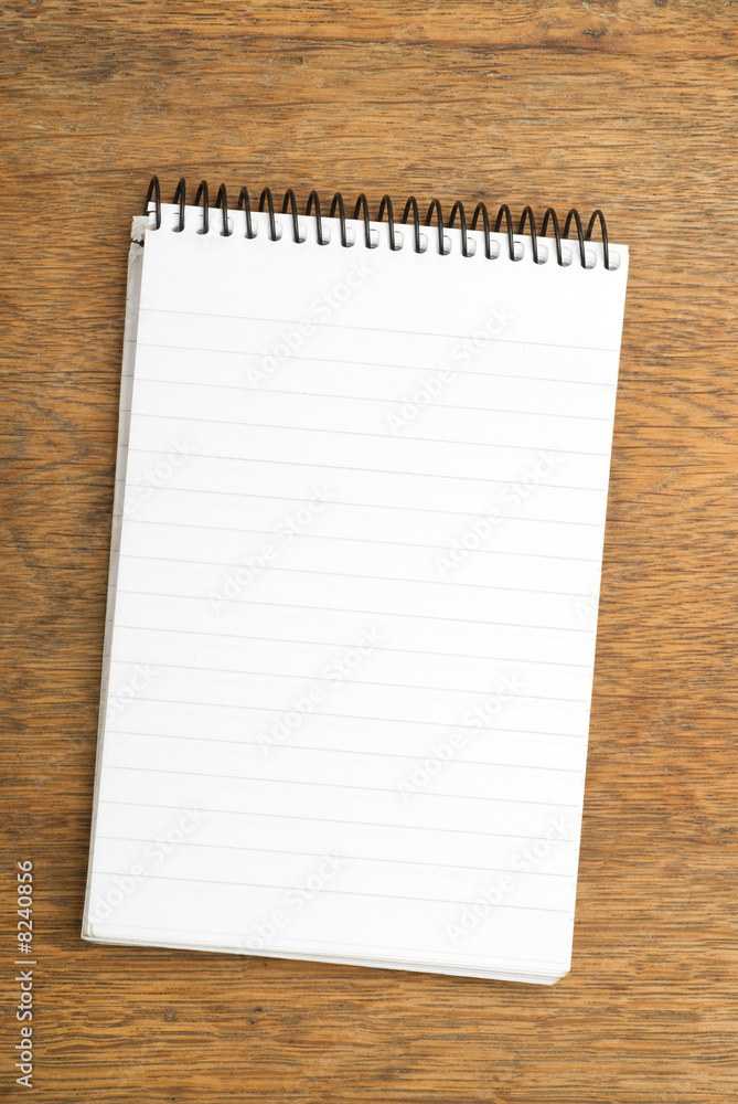 Spiral Notepad on wooden table Spiral Notepad on wooden table