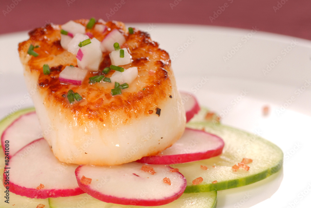 Seared scallop on a bed of radish and cucumber Seared scallop on a bed of radish and cucumber