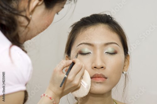 young woman applying makeup