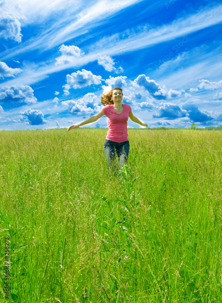 beautiful spreading her arms in the middle of a field beautiful spreading her arms in the middle of a field