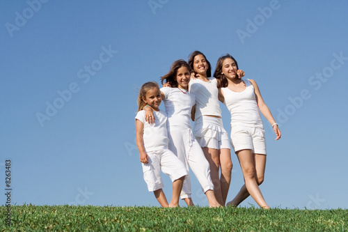 group of happy children walking in summer