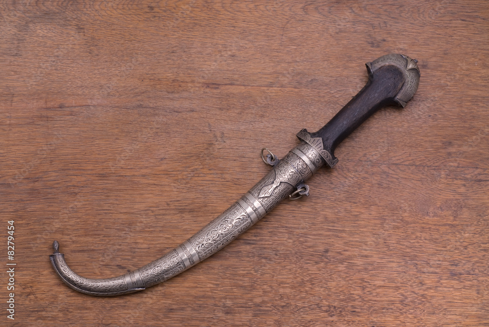 Arab traditional dagger on a wooden table Arab traditional dagger on a wooden table