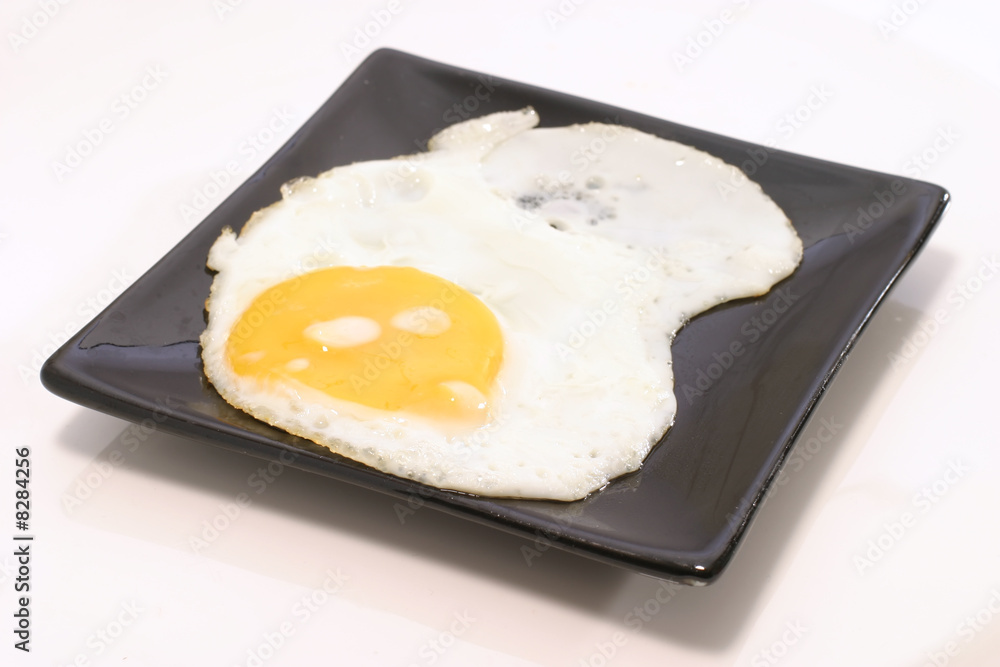 fried egg on black dish fried egg on black dish