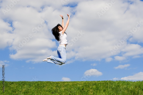 expressive young woman is jumping