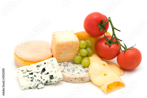 cheese assortment and vegetables on white background
