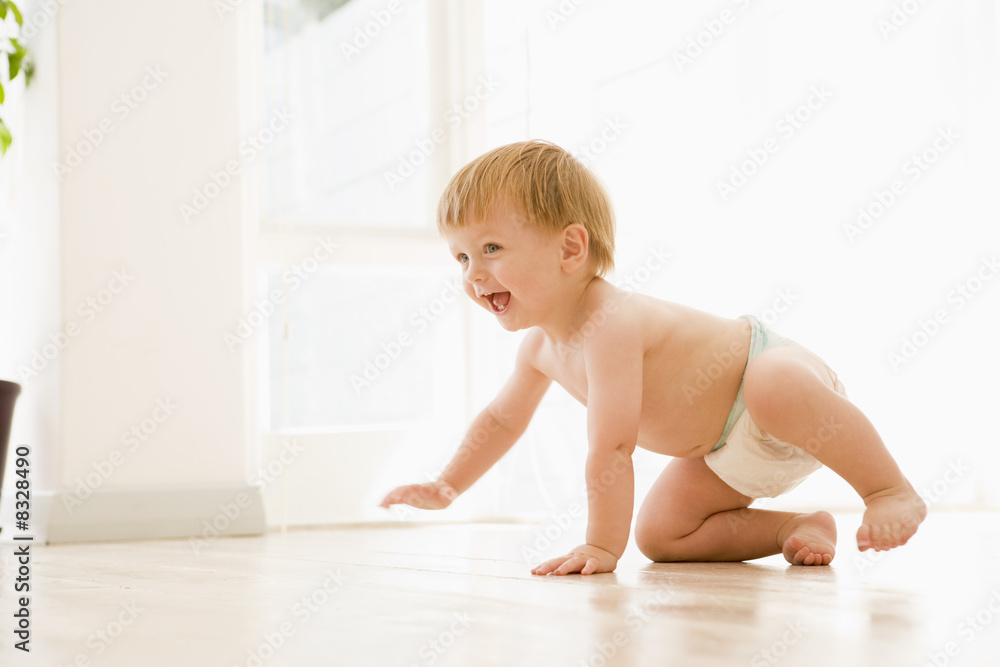 Baby crawling indoors smiling Baby crawling indoors smiling