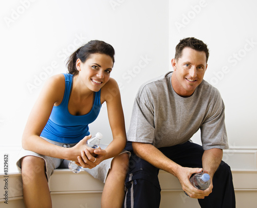 Male and female sitting smiling.