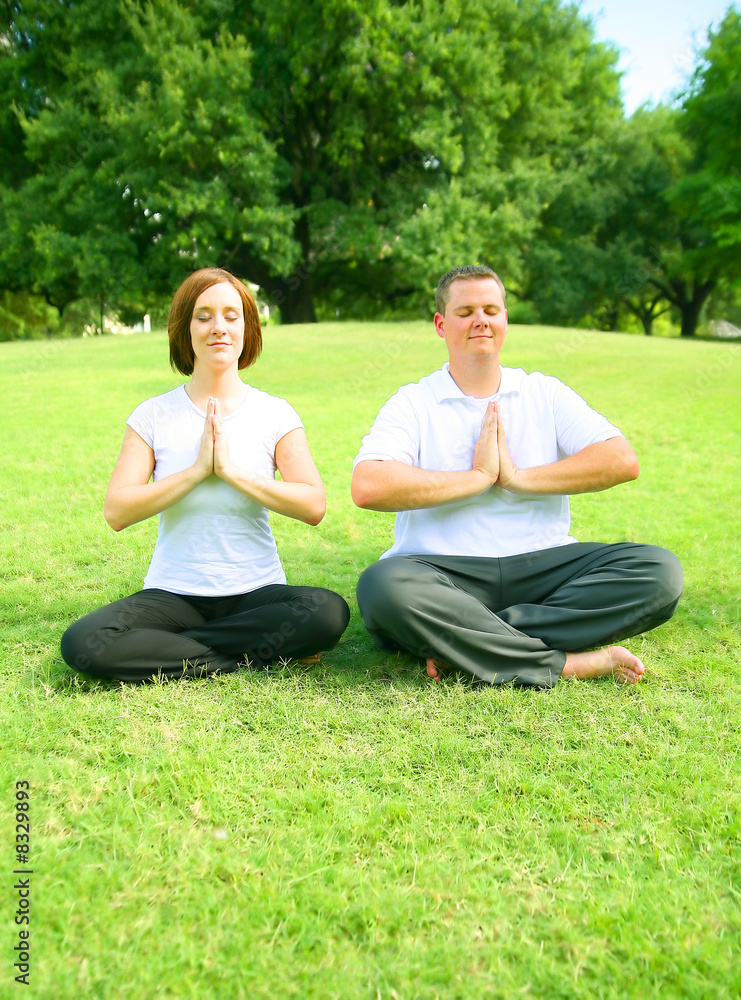 Couple Meditating In Park Couple Meditating In Park