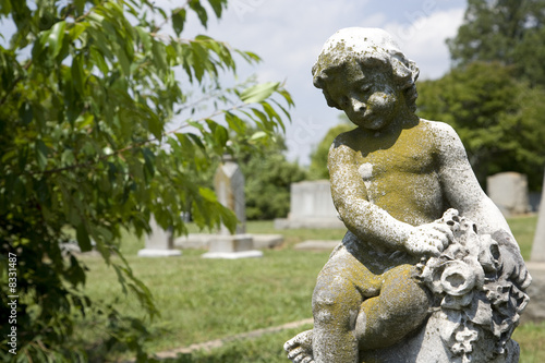 Cherub statue at graveyard.