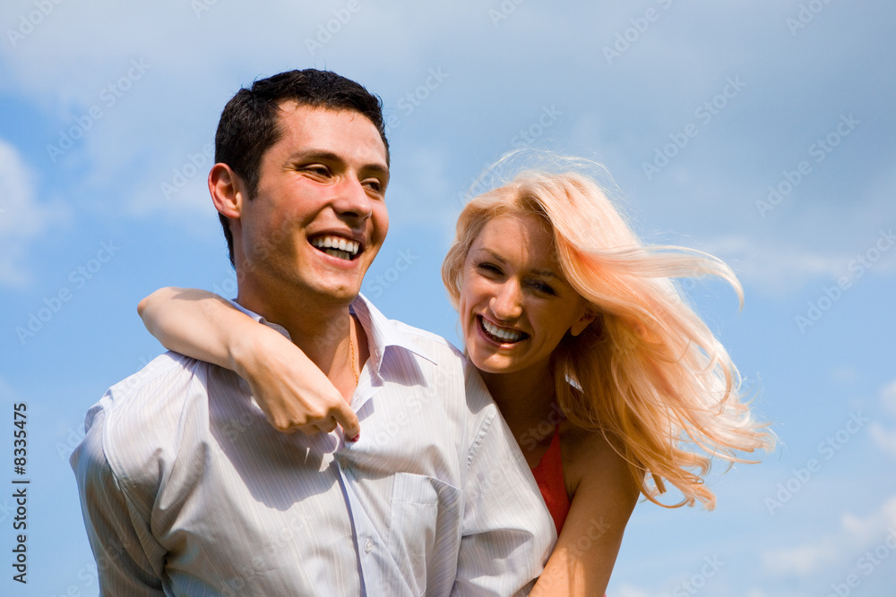 Young love Couple smiling under blue sky Young love Couple smiling under blue sky
