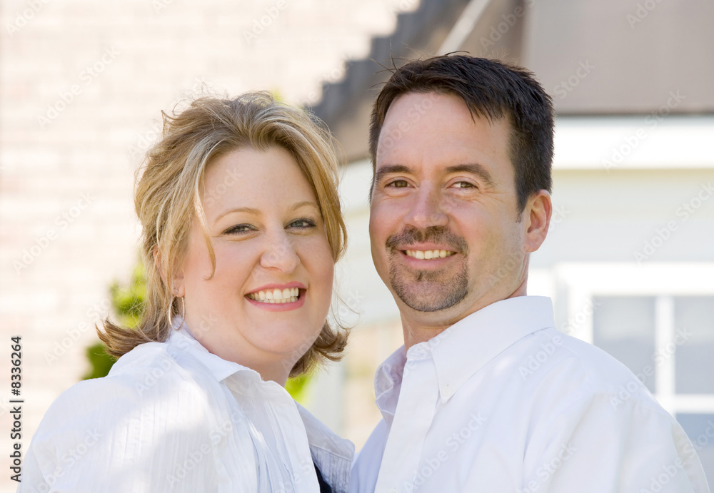 Happy Couple in Front of Their Home Happy Couple in Front of Their Home