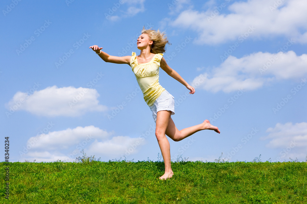 Happy young woman is running in a field. Happy young woman is running in a field.