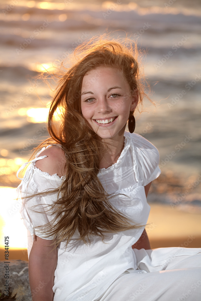 beautiful young girl relaxing on the beach at sunset beautiful young girl relaxing on the beach at sunset