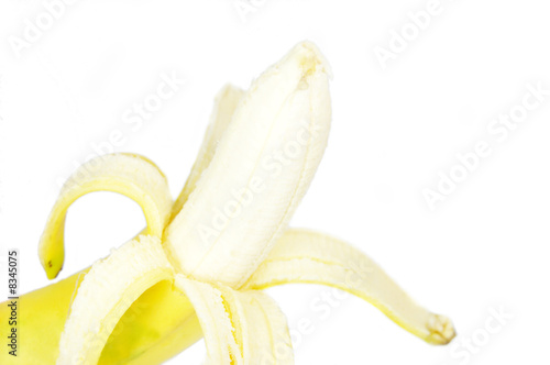 A single peeled fresh banana isolated on white background