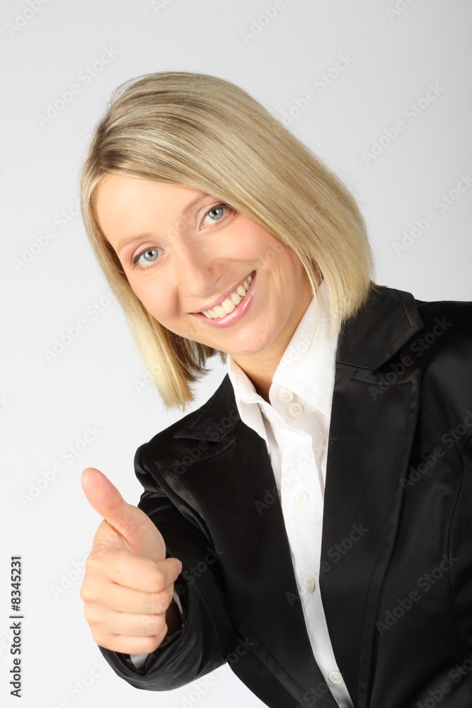 Pretty businesswoman showing thumb and smiling Pretty businesswoman showing thumb and smiling