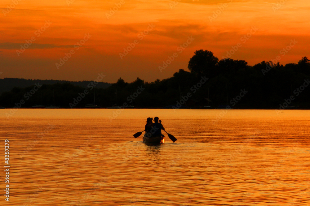 Paar mit Kanu beim Sonnenuntergang