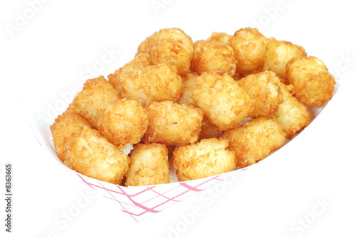 Fried tater tots in basket.  Isolated on white background.