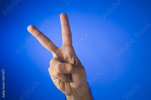 Victory sign on blue background