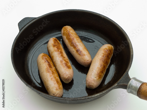 Sausage in frying pan.