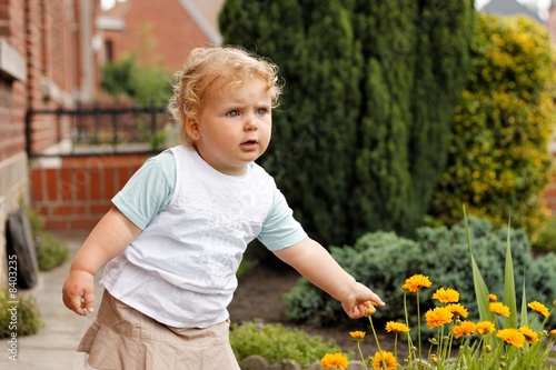 Petite fille cueillant  une fleur