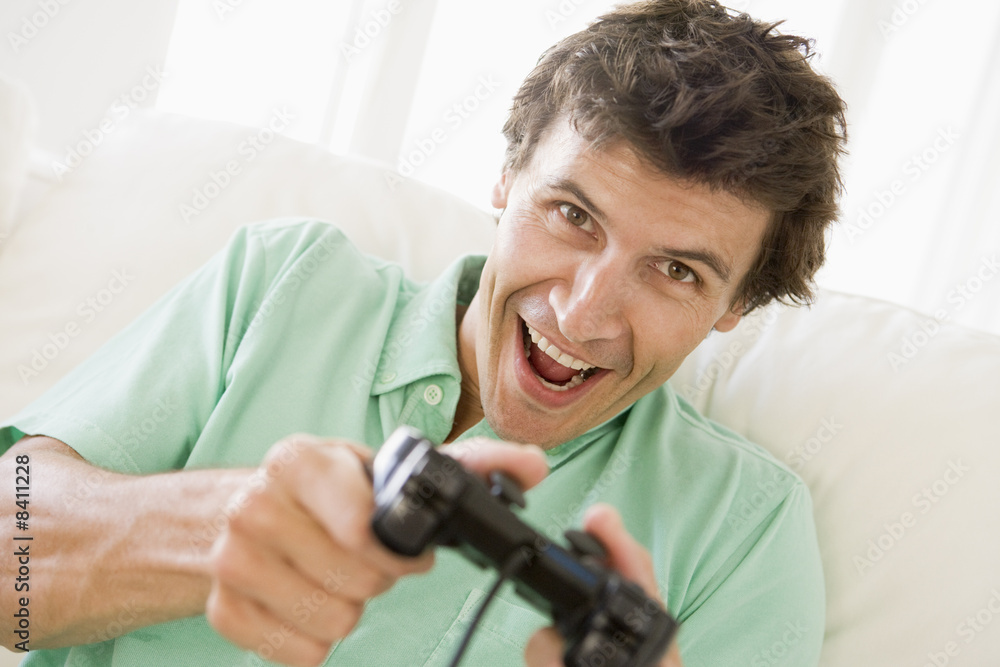Man in living room playing videogames smiling Man in living room playing videogames smiling