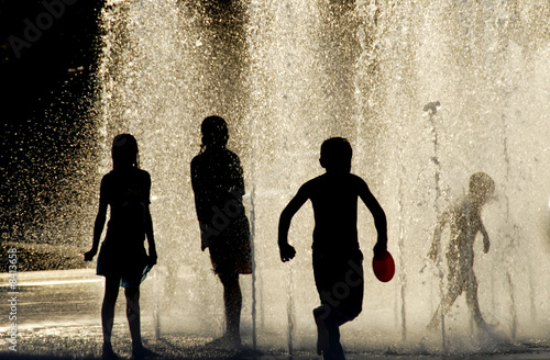 Children playing In a Fountain on a hot day 