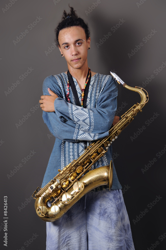 Naklejka premium Young musician with saxophone