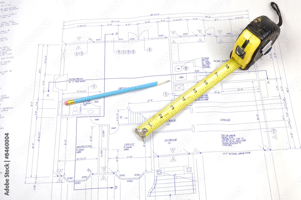 Building plans and tape measure Building plans and tape measure