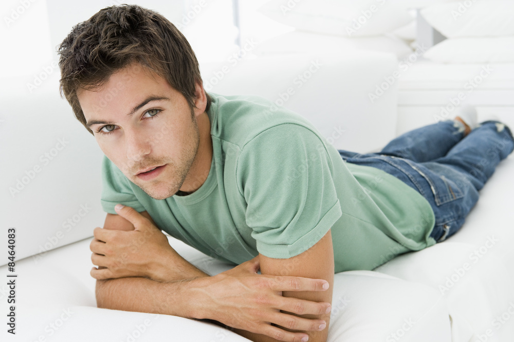 Fototapeta premium Man lying in living room