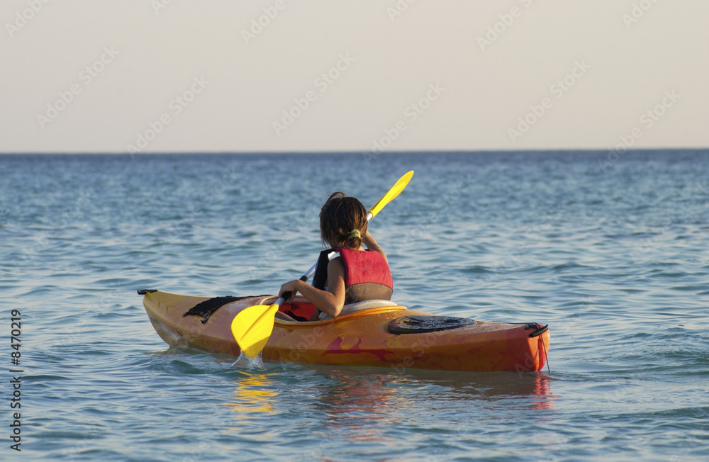 young caucasian girl learning to kayaking