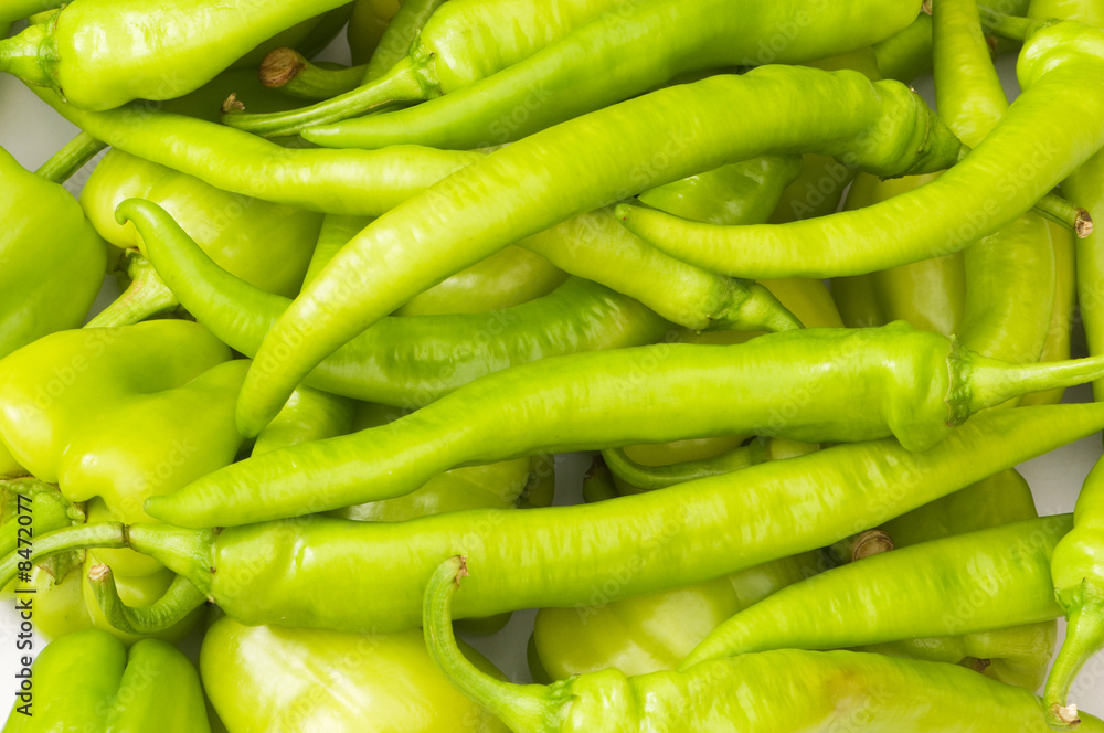 Many green hot peppers arranged at the market Many green hot peppers arranged at the market