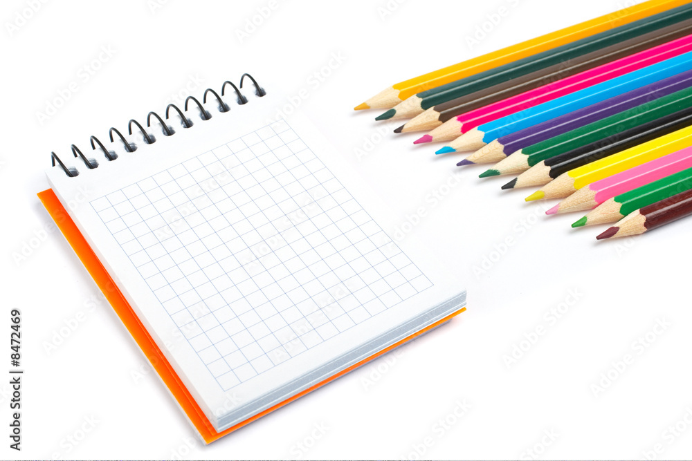 Blank notebook and coloured pencils Blank notebook and coloured pencils