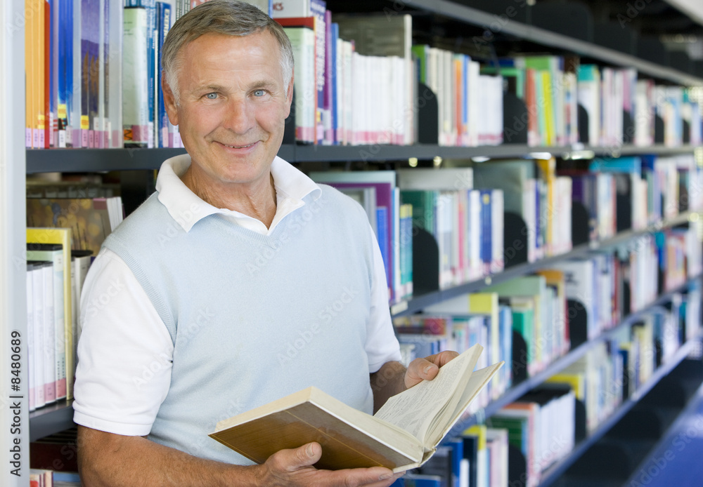 Senior man reading in a library Senior man reading in a library