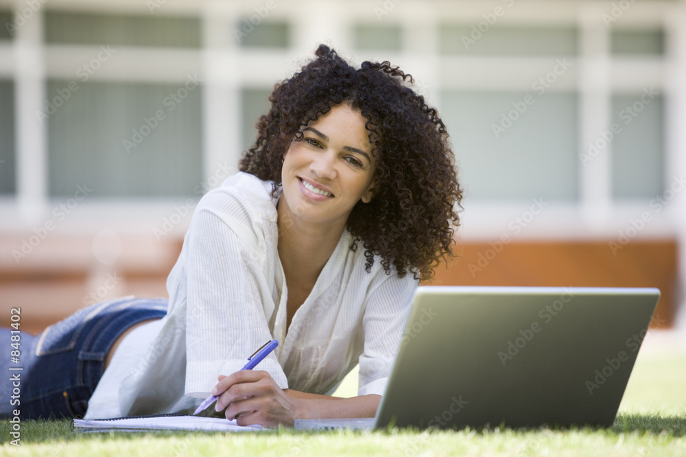 Woman using laptop on campus