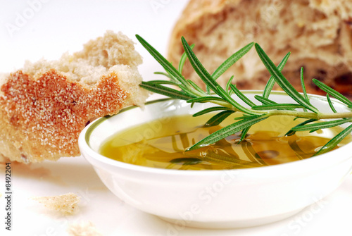Bowl of olive oil with rosemary and bread