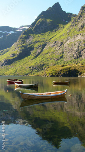 four boats and mirroring mountain