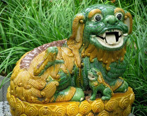 Pottery lion in grass