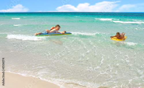 Fototapeta Naklejka Na Ścianę i Meble -  Family Playing in Ocean Surf
