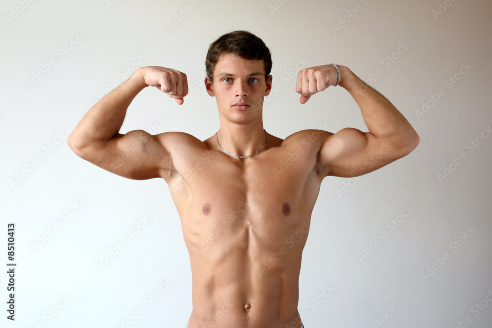 flexing Muscular Man Flexing His Biceps Stock Photo | Adobe Stock